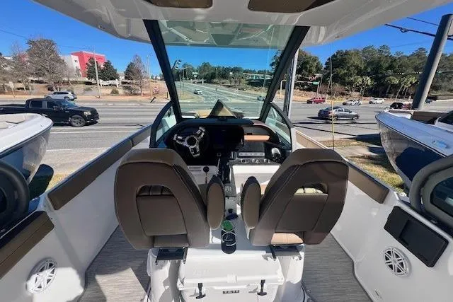 Slide: The Image of Luxurious interior seating of 2026 Monterey Elite 27 OB boat with tan upholstery. - 7