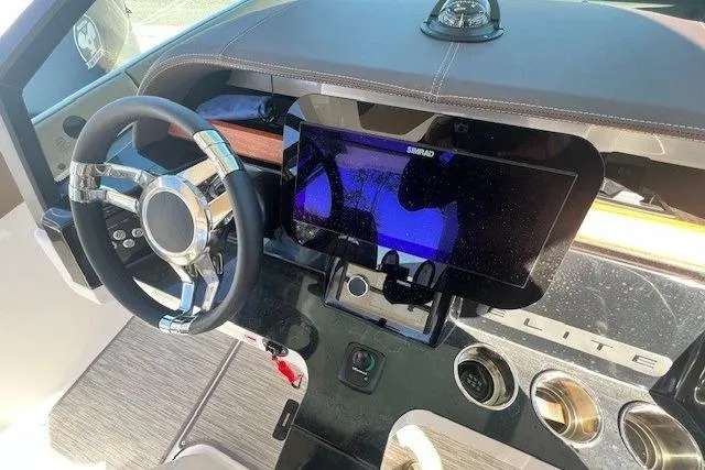 Slide: The Image of 2026 Monterey Elite 27 OB boat interior with tan seating and Mercury engines. - 8