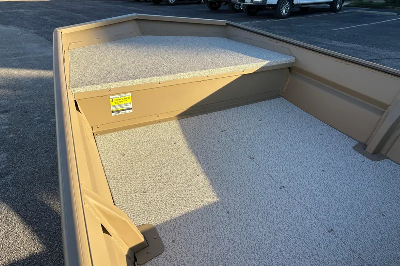 Slide: The Image of 2026 SeaArk 1648 MV boat interior with textured flooring and storage compartment. - 13