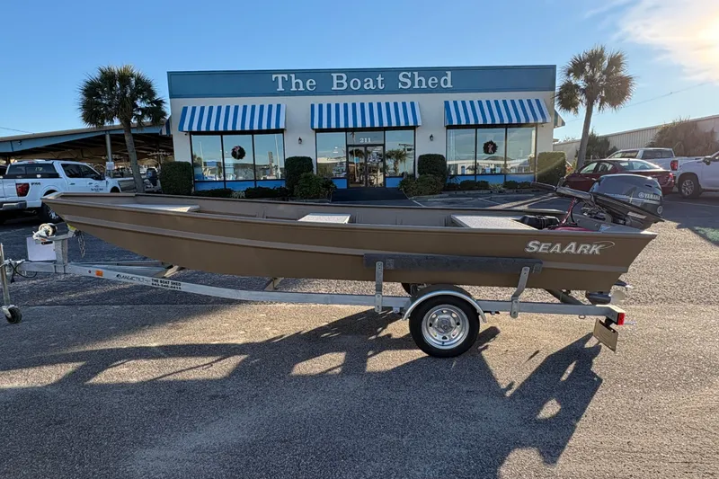 The Image of 2026 SeaArk 1648 MV boat on trailer outside The Boat Shed dealership. - 2