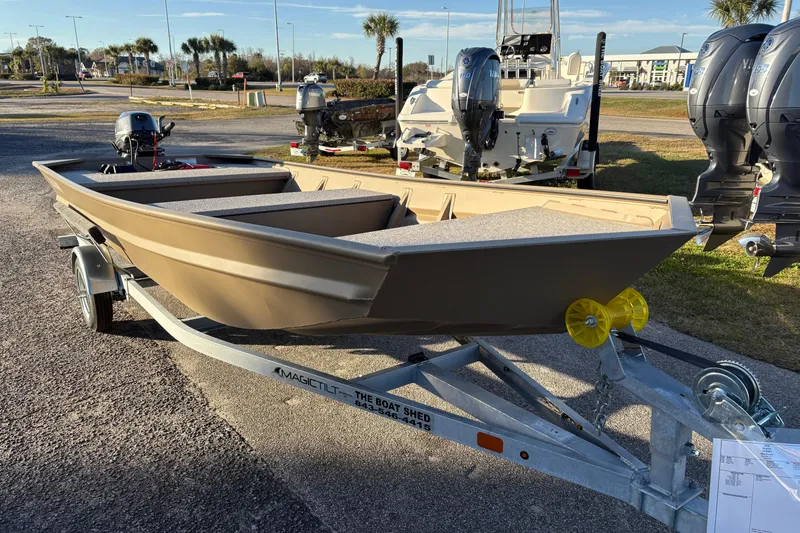Slide: The Image of 2026 SeaArk 1648 MV boat on trailer, parked outdoors with other boats. - 7