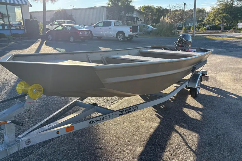 Slide: The Image of 2026 SeaArk 1648 MV boat on trailer in sunny parking lot. - 9