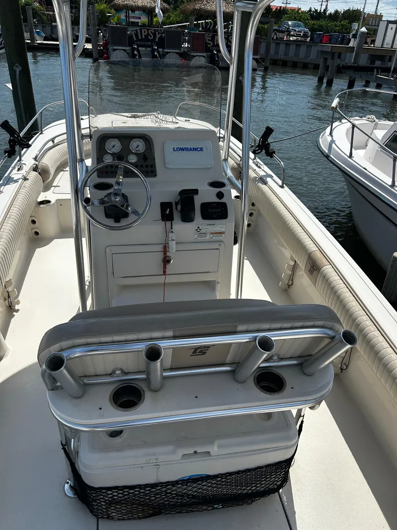 Slide: The Image of 2015 Carolina Skiff 21 Ultra Elite boat interior with steering console and rod holders. - 11