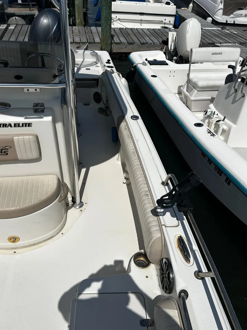 Slide: The Image of 2015 Carolina Skiff 21 Ultra Elite boat docked, featuring seating and console details. - 26