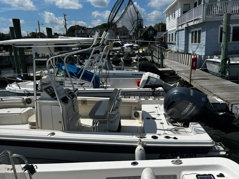 Slide: The Image of 2015 Carolina Skiff 21 Ultra Elite docked with Yamaha outboard motor, sunny day. - 29