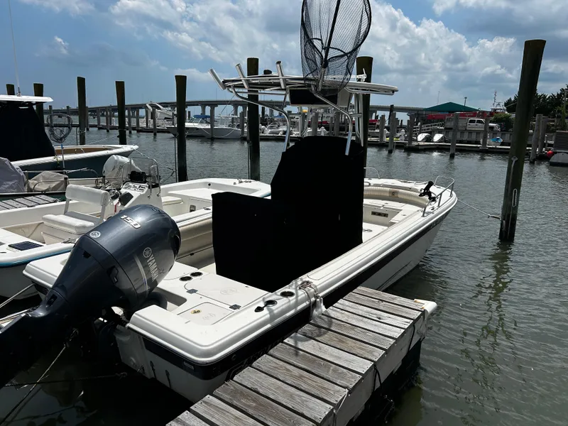 Slide: The Image of 2015 Carolina Skiff 21 Ultra Elite boat docked at marina with Yamaha outboard motor. - 4