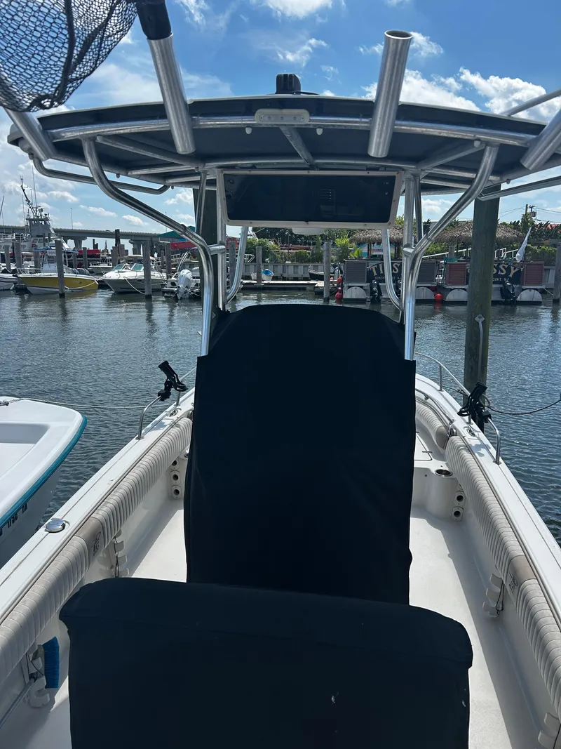 Slide: The Image of 2015 Carolina Skiff 21 Ultra Elite boat docked at marina under blue sky. - 7