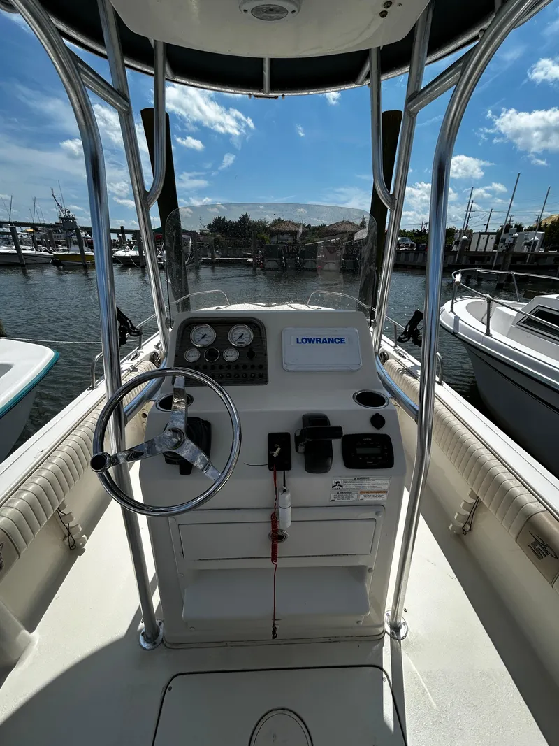 Slide: The Image of 2015 Carolina Skiff 21 Ultra Elite boat console with steering wheel and navigation equipment. - 9