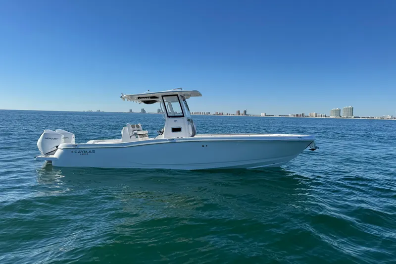 Slide: The Image of 2026 Caymas 291 boat on open water with city skyline in background. - 10