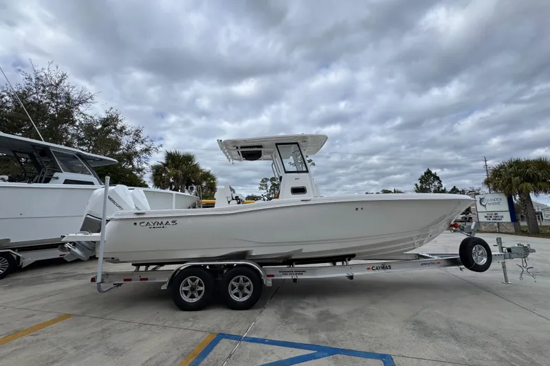 Slide: The Image of 2026 Caymas 291 boat on trailer under cloudy sky at marina. - 19