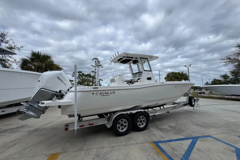 Slide: The Image of 2026 Caymas 291 boat on trailer, parked outdoors under cloudy sky. - 20