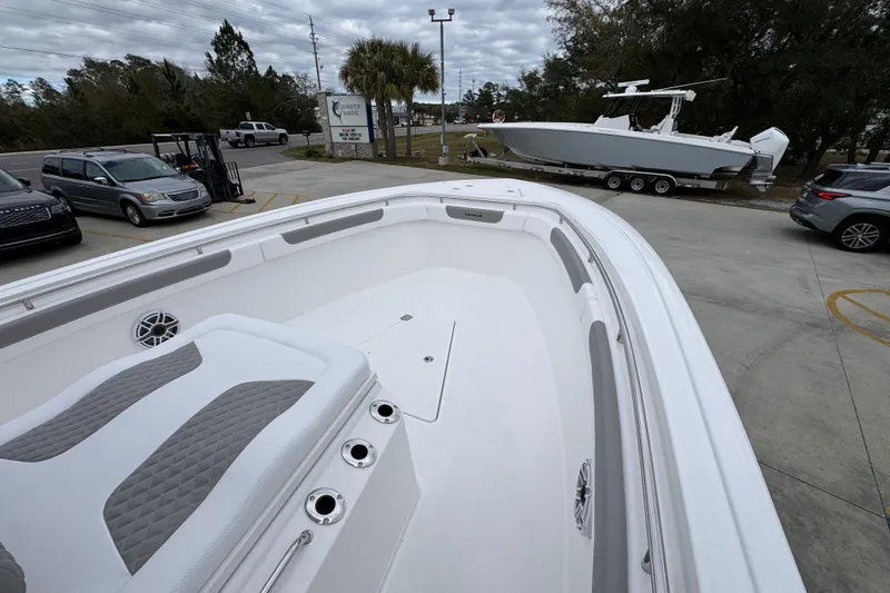 Slide: The Image of 2026 Caymas 291 boat with sleek design in a parking lot setting. - 25