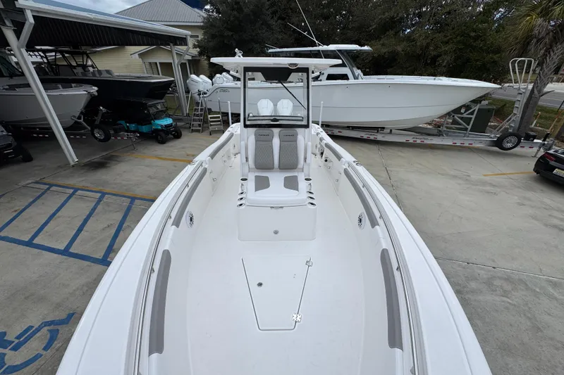 Slide: The Image of 2026 Caymas 291 boat, white interior, docked in a marina with other boats. - 29