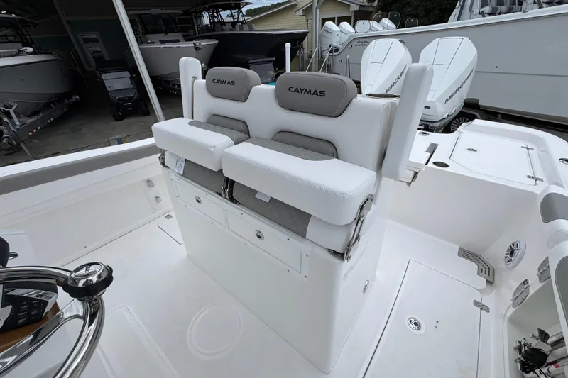 Slide: The Image of 2026 Caymas 291 boat interior with dual cushioned seats and steering wheel. - 33