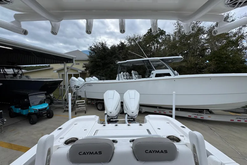 Slide: The Image of 2026 Caymas 291 boat with dual engines on a trailer in a marina. - 35