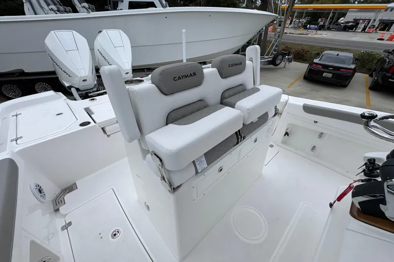 Slide: The Image of 2026 Caymas 291 boat interior with dual Mercury engines and cushioned seating. - 36