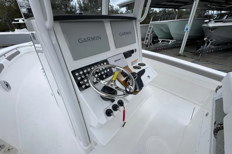 Slide: The Image of 2026 Caymas 291 boat console with Garmin displays and steering wheel. - 37