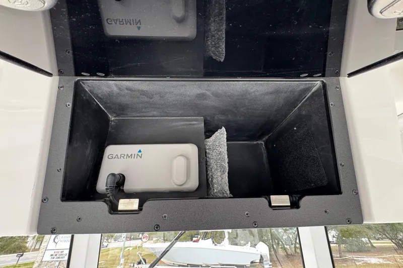 Slide: The Image of Storage compartment in 2026 Caymas 291 boat with Garmin device inside. - 40