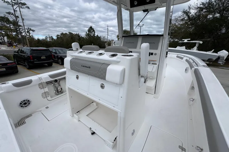 Slide: The Image of 2026 Caymas 291 boat interior with helm station and seating, parked outdoors. - 42