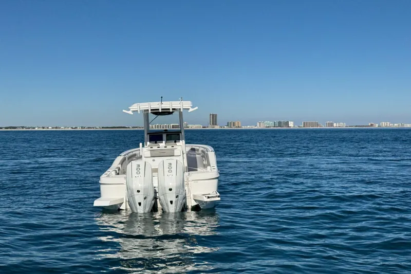 Slide: The Image of 2026 Caymas 291 boat on open water with city skyline in background. - 7