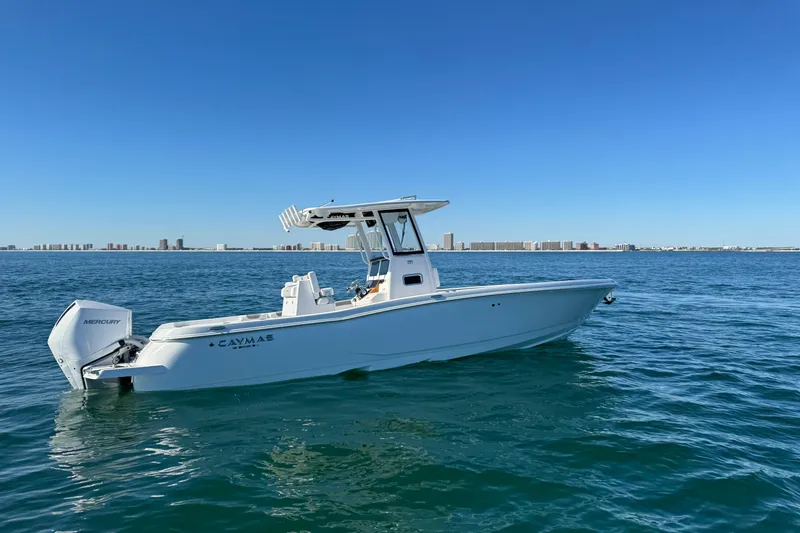 Slide: The Image of 2026 Caymas 291 boat on open water with city skyline in background. - 9