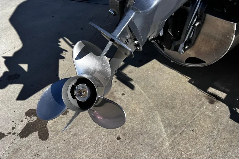 Slide: The Image of Close-up of a 2022 Godfrey Monaco 235 SFL boat propeller on concrete surface. - 17