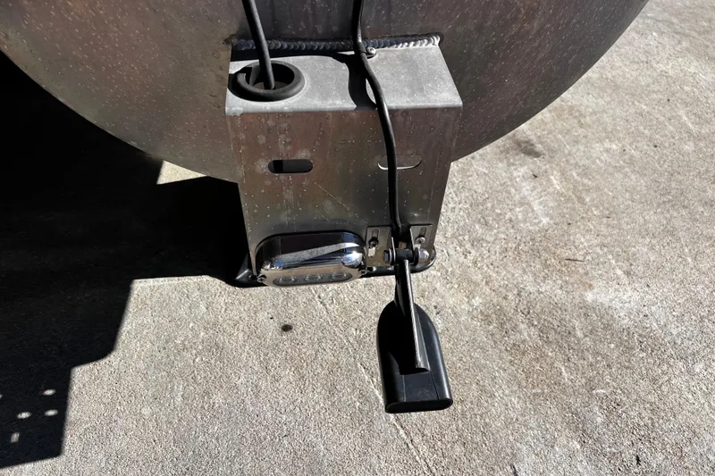 Slide: The Image of Close-up of a 2022 Godfrey Monaco 235 SFL boat component on concrete surface. - 21