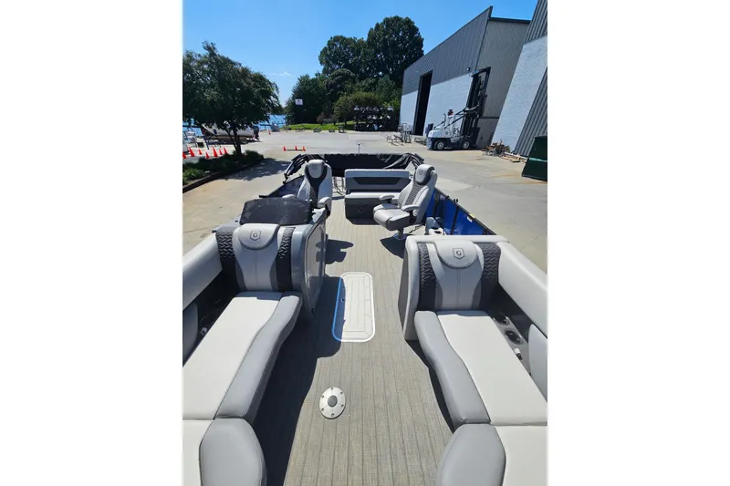 Slide: The Image of 2022 Godfrey Monaco 235 SFL pontoon boat with Yamaha engine, docked outdoors. - 4