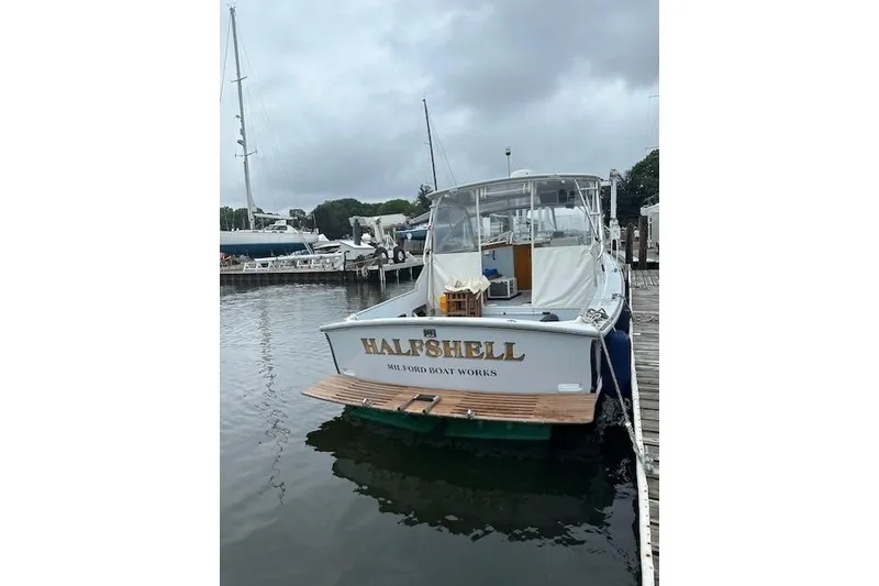 Slide: The Image of 1978 Dyer 40 Express Cruiser docked at marina, named "HALFSHELL". - 1
