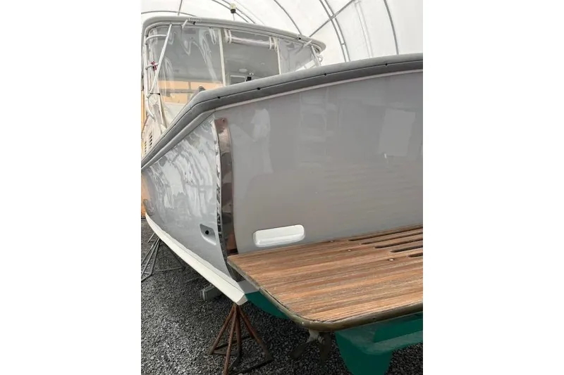 Slide: The Image of 1978 Dyer 40 Express Cruiser with wooden deck, under a protective cover. - 10