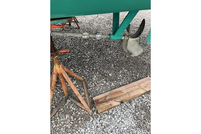 Slide: The Image of 1978 Dyer 40 Express Cruiser propeller and shaft on gravel. - 13