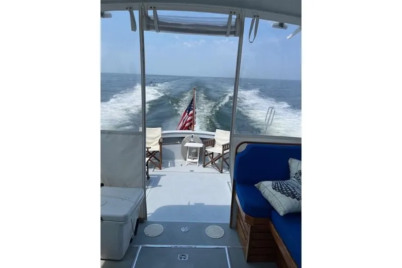 Slide: The Image of 1978 Dyer 40 Express Cruiser interior with ocean view and American flag. - 14
