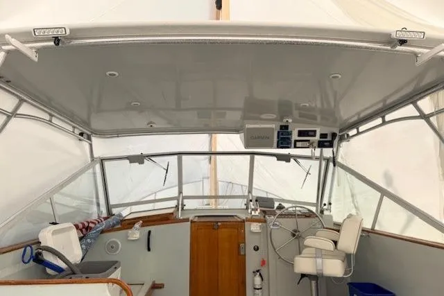 Slide: The Image of 1978 Dyer 40 Custom Express Cruiser helm with covered seating and navigation equipment. - 19