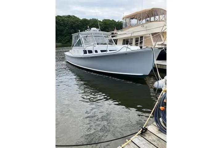 Slide: The Image of 1978 Dyer 40 Express Cruiser docked on calm water. - 2