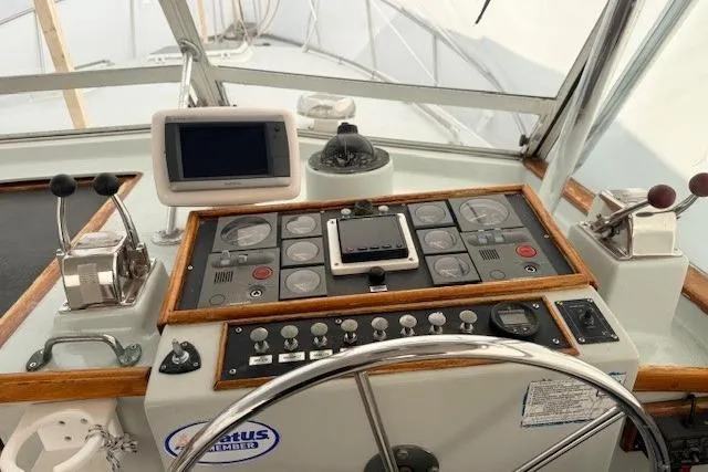 Slide: The Image of 1978 Dyer 40 Custom Express Cruiser helm with navigation instruments and steering wheel. - 20