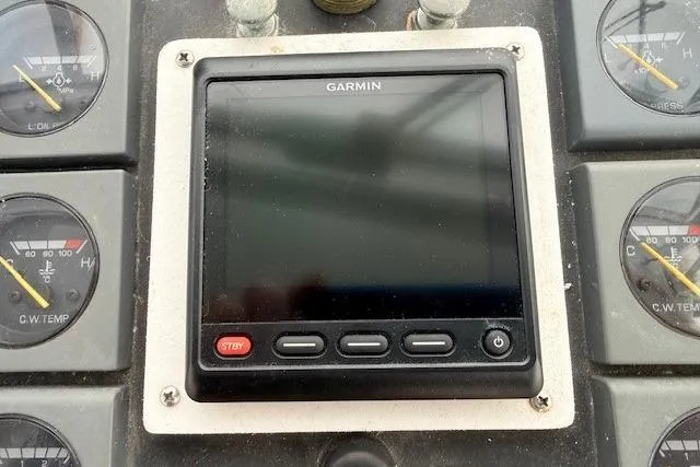 Slide: The Image of Garmin display on 1978 Dyer 40 Custom Express Cruiser dashboard with gauges. - 22