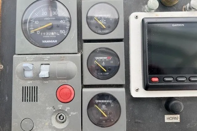 Slide: The Image of 1978 Dyer 40 Custom Express Cruiser dashboard with gauges and Garmin display. - 23