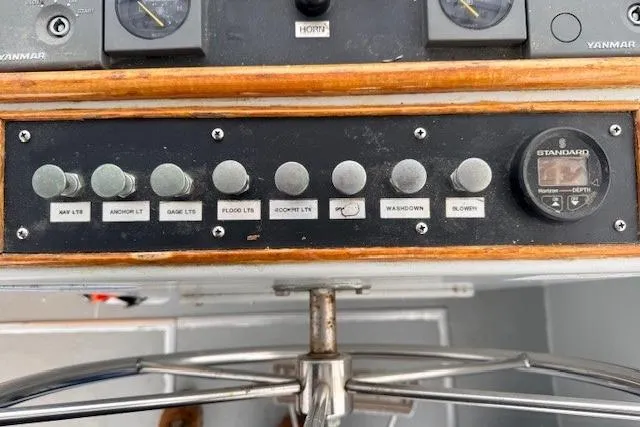 Slide: The Image of Control panel of a 1978 Dyer 40 Custom Express Cruiser with various switches and gauges. - 32