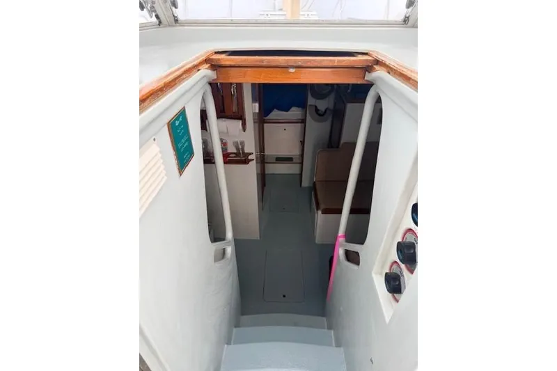 Slide: The Image of 1978 Dyer 40 Custom Express Cruiser interior view with stairs and cabin. - 36