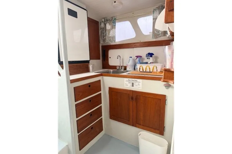 Slide: The Image of 1978 Dyer 40 Custom Express Cruiser galley with wooden cabinets and sink. - 40