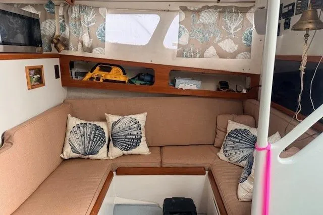 Slide: The Image of Interior of 1978 Dyer 40 Custom Express Cruiser with cozy seating and nautical decor. - 44