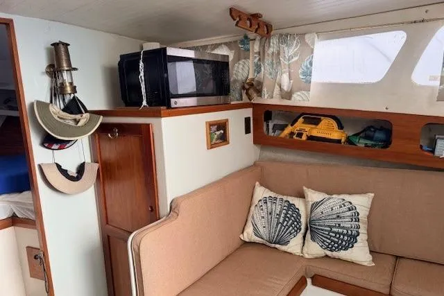 Slide: The Image of 1978 Dyer 40 Custom Express Cruiser interior with cozy seating and nautical decor. - 45