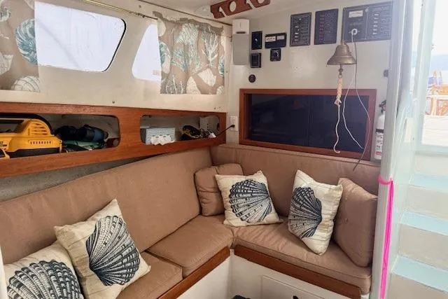 Slide: The Image of Cozy interior of 1978 Dyer 40 Custom Express Cruiser with beige seating and nautical decor. - 46