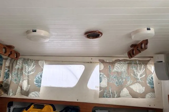 Slide: The Image of Interior of 1978 Dyer 40 Custom Express Cruiser with patterned curtains and wooden accents. - 47