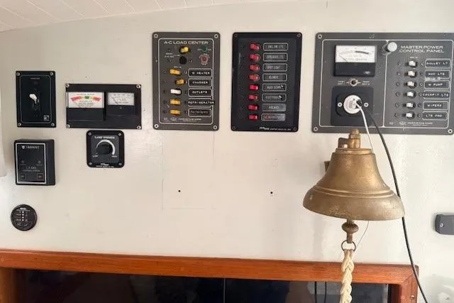 Slide: The Image of Control panel of a 1978 Dyer 40 Custom Express Cruiser with brass bell. - 48