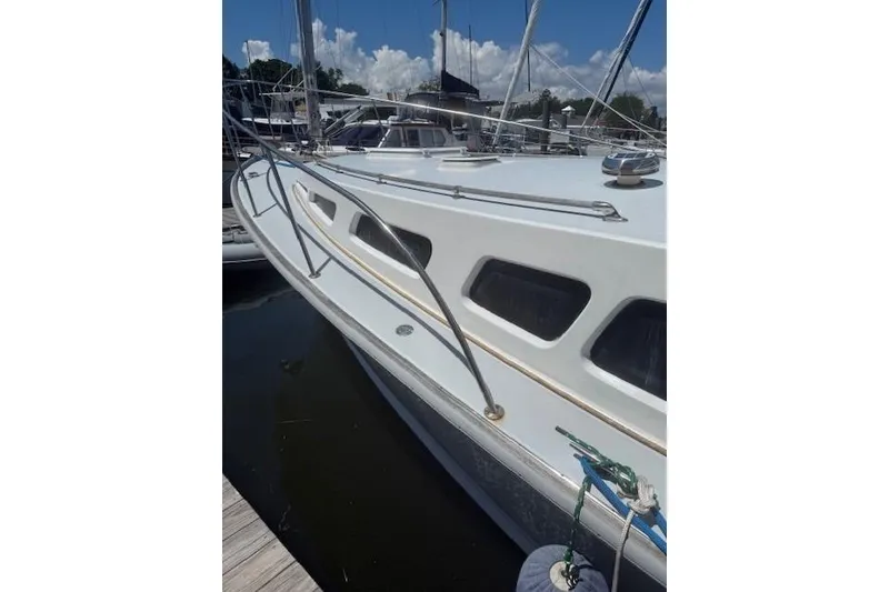 Slide: The Image of 1978 Dyer 40 Express Cruiser docked, showcasing sleek design and windows. - 5