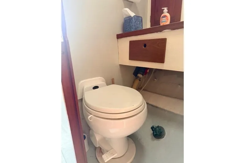 Slide: The Image of 1978 Dyer 40 Custom Express Cruiser bathroom with toilet and wooden cabinet. - 55