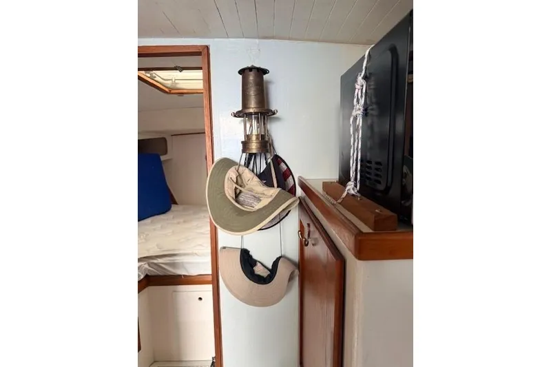 Slide: The Image of Interior of 1978 Dyer 40 Custom Express Cruiser with hats and lantern. - 57