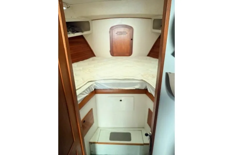 Slide: The Image of 1978 Dyer 40 Custom Express Cruiser cabin interior with bed and wooden accents. - 58