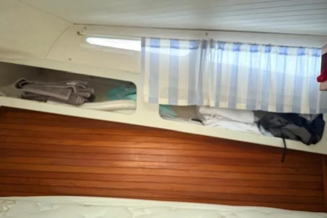 Slide: The Image of Interior of 1978 Dyer 40 Custom Express Cruiser with wooden paneling and storage compartments. - 62